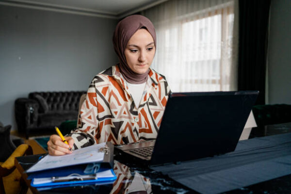 Boost Your IELTS Score with Dubai’s Best Online Preparation Courses girl study online and writing